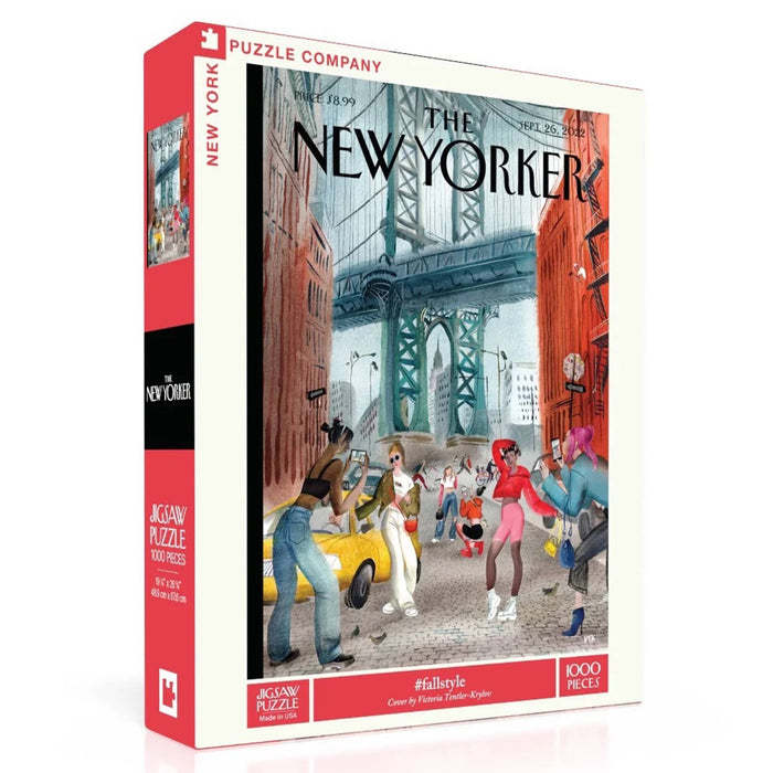 A 1000-piece jigsaw puzzle box of a The New Yorker cover, featuring a colorful illustration of a city street scene with pedestrians, a yellow cab, and a bridge in the background. The box is shown at a three-quarter angle on a clean white background.