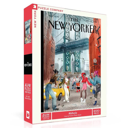A 1000-piece jigsaw puzzle box of a The New Yorker cover, featuring a colorful illustration of a city street scene with pedestrians, a yellow cab, and a bridge in the background. The box is shown at a three-quarter angle on a clean white background.