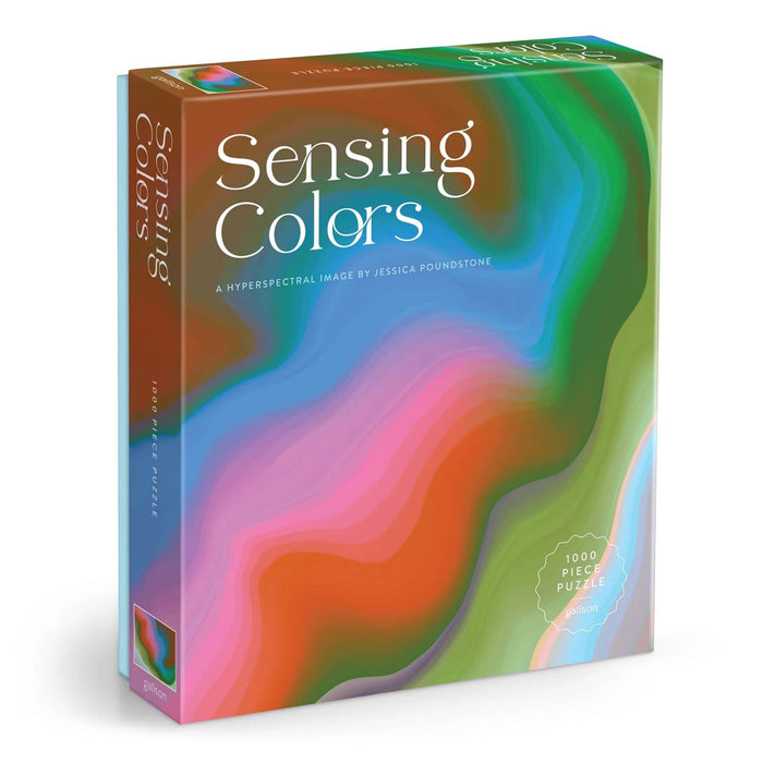The product packaging for the 'Sensing Colors' 1000-piece puzzle by Jessica Poundstone, featuring a vibrant, abstract fluid art design with swirling waves of green, blue, pink, orange, and purple. Front angle view shown on a plain white background.