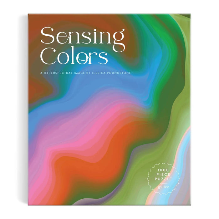 The product packaging for the 'Sensing Colors' 1000-piece puzzle by Jessica Poundstone, featuring a vibrant, abstract fluid art design with swirling waves of green, blue, pink, orange, and purple. Front view shown on a plain white background.