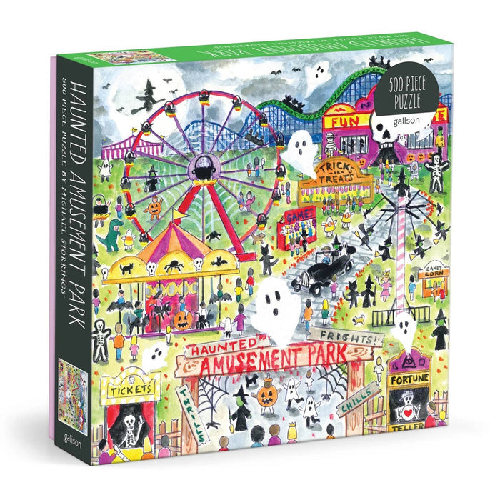 A 500-piece jigsaw puzzle box titled 'Haunted Amusement Park' by Galison, featuring a colorful, whimsical illustration of a Halloween-themed fairground with a ferris wheel, carousel, ghosts, and playful figures.