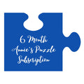 An illustration of a blue puzzle piece with "6 month annie's puzzle subscription" in white lettering.
