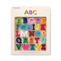 A package of ABC Crayons alphabet set, featuring 26 colorful textured letter crayons arranged in a grid inside a cream-colored cardboard holder with a clear window.