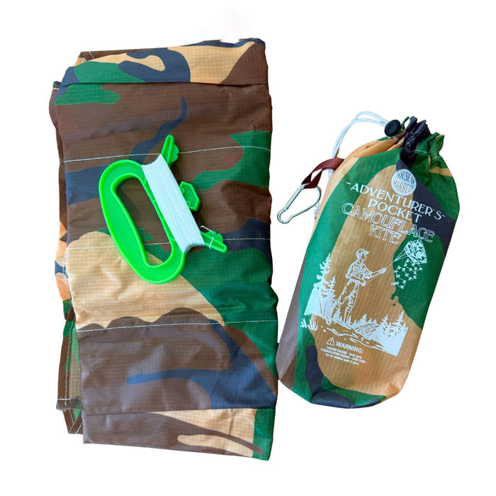 Camouflage kite with string and holder with a matching drawstring bag with branding on a white background.
