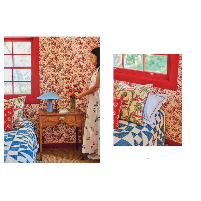 Decorative bedroom with floral wallpaper, colorful bedding, and a small table with a lamp.