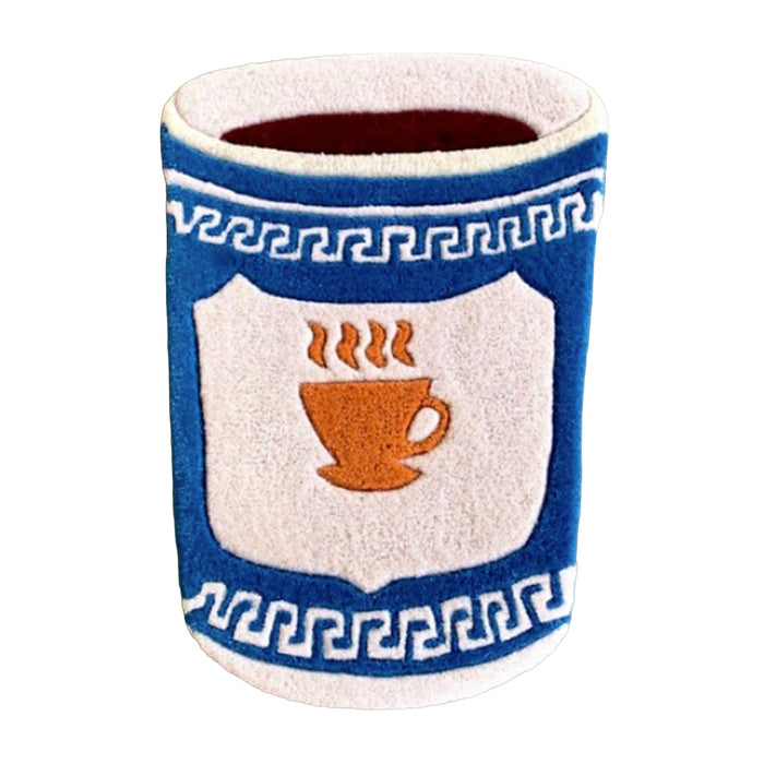 A tufted accent rug shaped like a cup with the Anthora coffee cup design, including a blue and white Greek key pattern and a central shield design featuring an orange coffee cup with steam, shown on a plain white background.