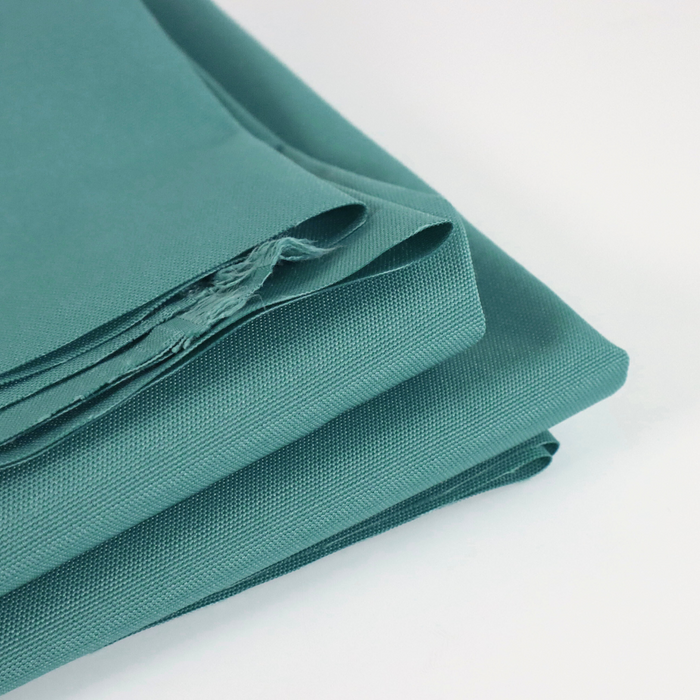 This ReNew Solid is in a de-staurated shade of teal that gives it an antique-like color. This photo is of the fabric folded.