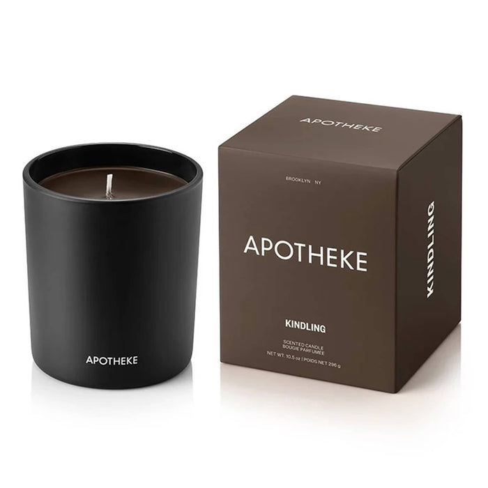 Black Apotheke candle and dark brown packaging on a white background.