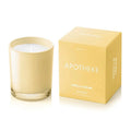 Apotheke Vanilla Cream scented candle in a soft yellow glass vessel and its matching box on a white background.