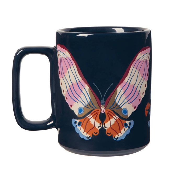 Navy mug with a colorful butterfly design, handle on the left, on a white background.