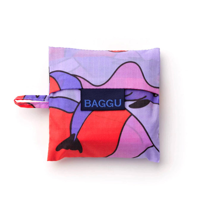 Baby Baggu reusable shopping bag with colorful dolphin design in matching pouch, on a white background.
