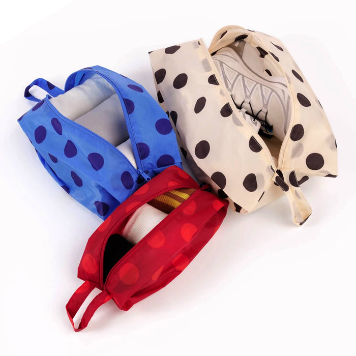 Three reusable zippered pouches in blue, cream, and red polka dot fabric, shown partially open on a white background.