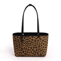 A leopard print tote bag with black handles and a black interior, shown against a plain white background.