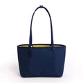 A navy blue fabric tote bag with a bright yellow interior lining, featuring two shoulder straps, shown against a plain white background.