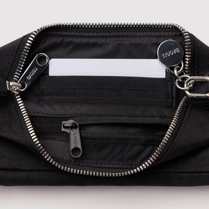 Black bag with zippers and a visible brand logo on a light gray background.