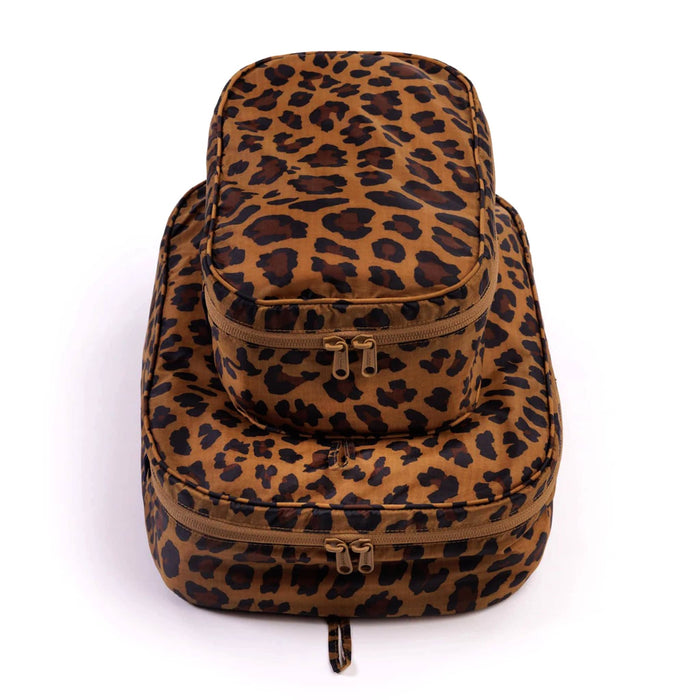 Set of 2 recycled nylon packing cubes with leopard print on a white background.