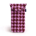 A pink and brown quilted fabric glasses pouch with a houndstooth pattern, featuring a fold-over flap and a small dark blue brand tag on the side, on a white background.