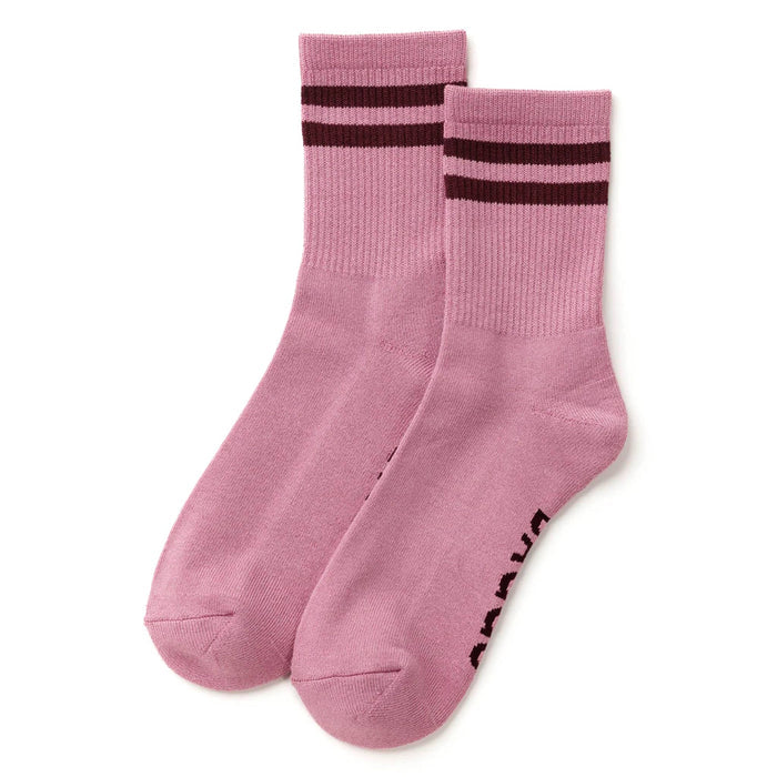 A pair of plum crew socks with two dark burgundy stripes near the ribbed cuffs and burgundy text branding printed on the sole, displayed on a clean white background.