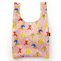Reusable shopping bag with teddy bear pattern on a pink background.