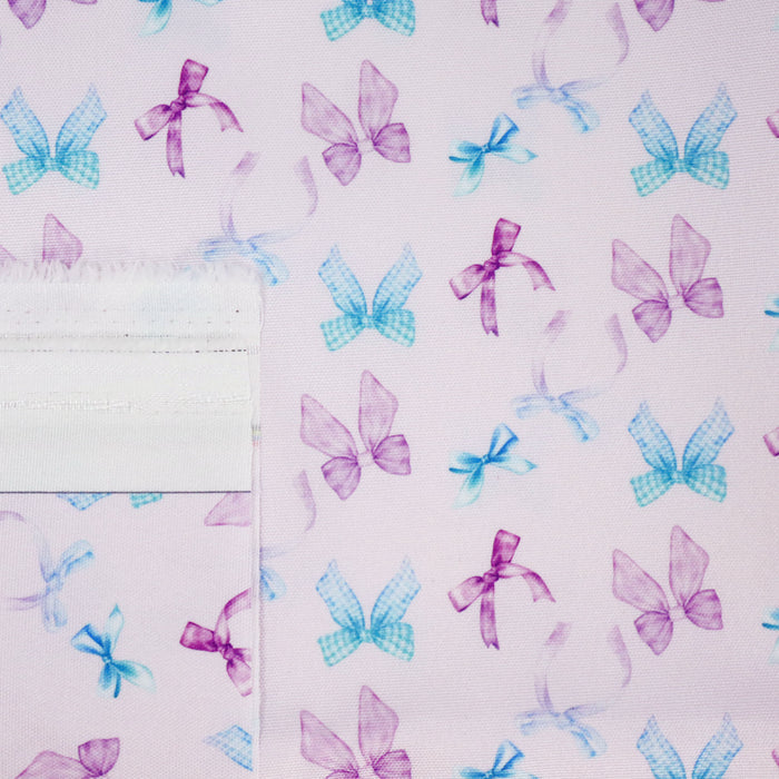 This printed WPC-Lite consists of a variety of styled bows in blue, turquoise, purple, and magenta.