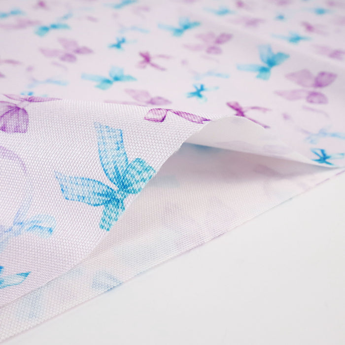This printed WPC-Lite consists of a variety of styled bows in blue, turquoise, purple, and magenta.