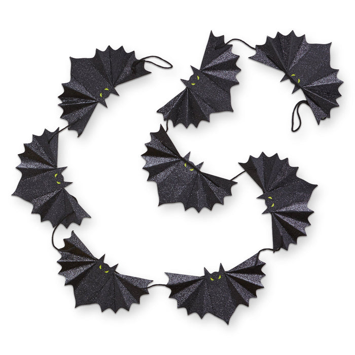 Black bat-shaped paper garland arranged in a circular pattern on a white background.