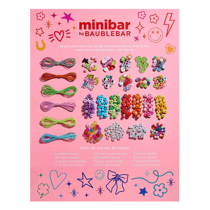 Minibar by BaubleBar jewelry making kit, back of pink box packaging showing included beads and strings, on a white background.