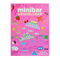 Pink packaging of a claw clip kit by Baublebar with various designs and text on a white background.