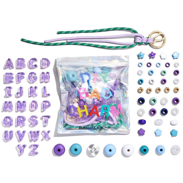 Bag charm kit with letters, beads, and string around pouch packaging, on a white background.