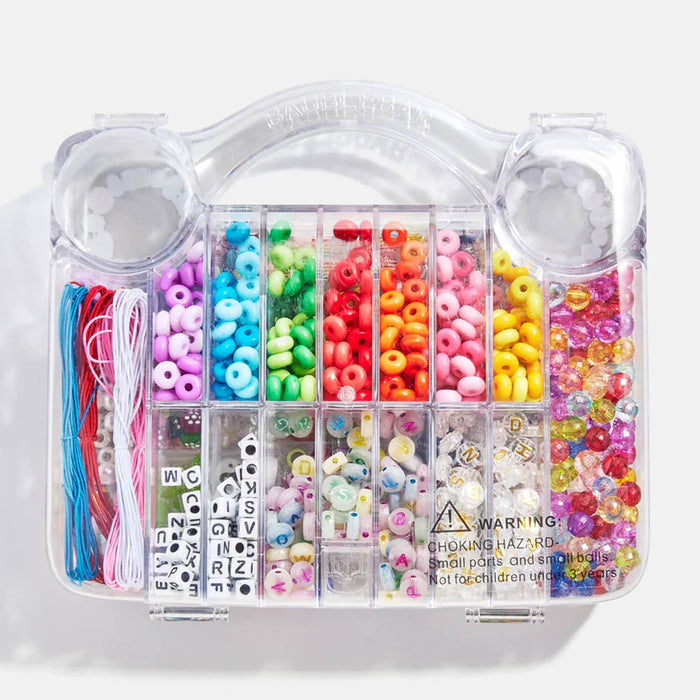 Bottom of a colorful bead set in a clear plastic case on a white background.
