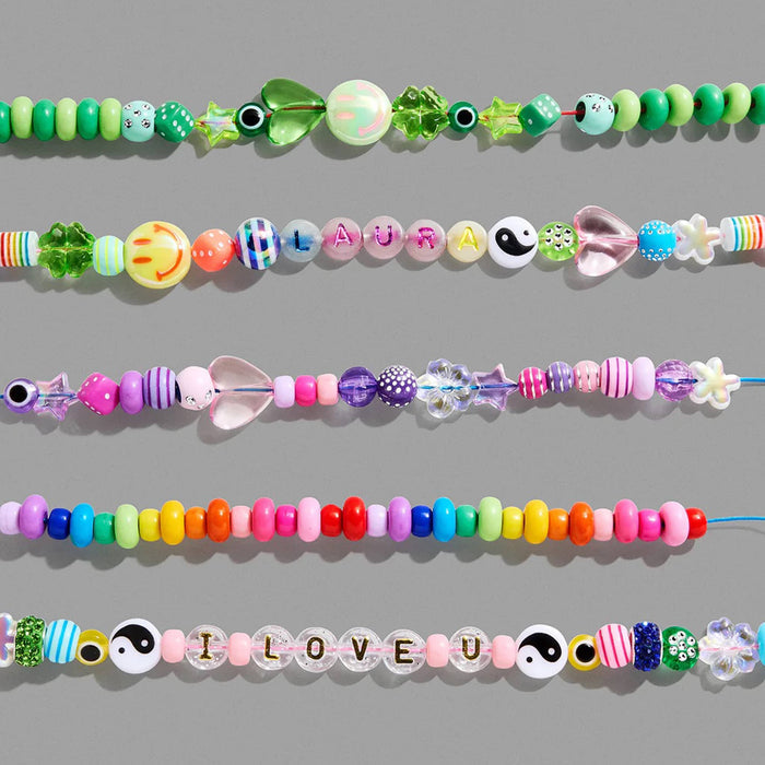 Colorful beaded bracelets on a gray background.