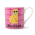 A white ceramic mug featuring a pink grid pattern with a yellow spotted cat wearing blue sunglasses and the text 'Be cool babes' in black script. Handle is on the right, on a white background.