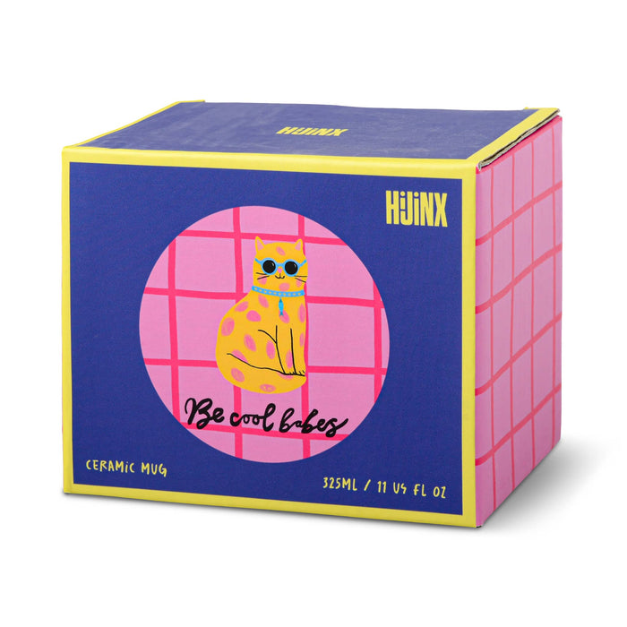 A gift box with a dark blue front face with a pink grid circle containing a yellow cat illustration and the text 'Be cool babes', with yellow borders and a pink grid pattern on the side.