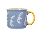 Blue mug with white seagull illustrations and a yellow handle, on the right, on a white background.