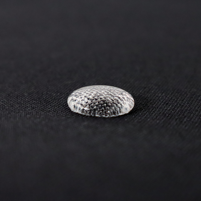 This WPC-Lite solid is in black. This photo shows a water drop on the fabric.