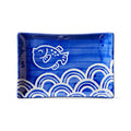 Blue rectangular dish with white fish and wave patterns, on a white background.