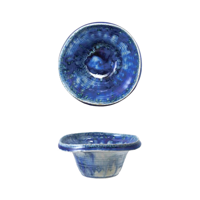 Overhead and side view of a blue stoneware footed bowl with blue crackle finish glaze, on a white background.