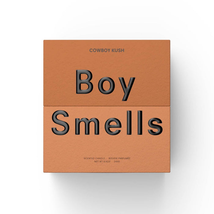 Boy Smells Cowboy Kush scented 9 ounce Classics candle in two-toned dark orange box.