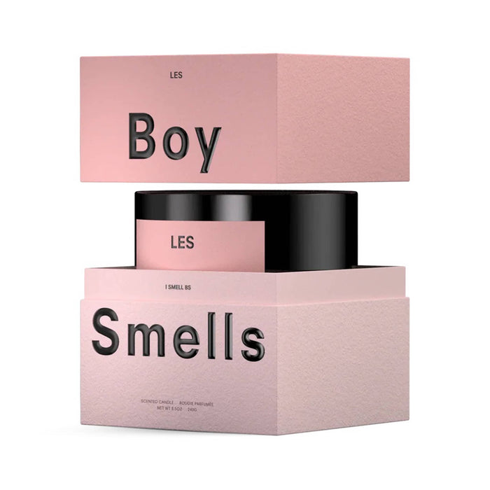 LES scented Boy Smells candle in matte black glass vessel with matte pink label, inside two-tone pink gift box, lid raised up, on a white background.