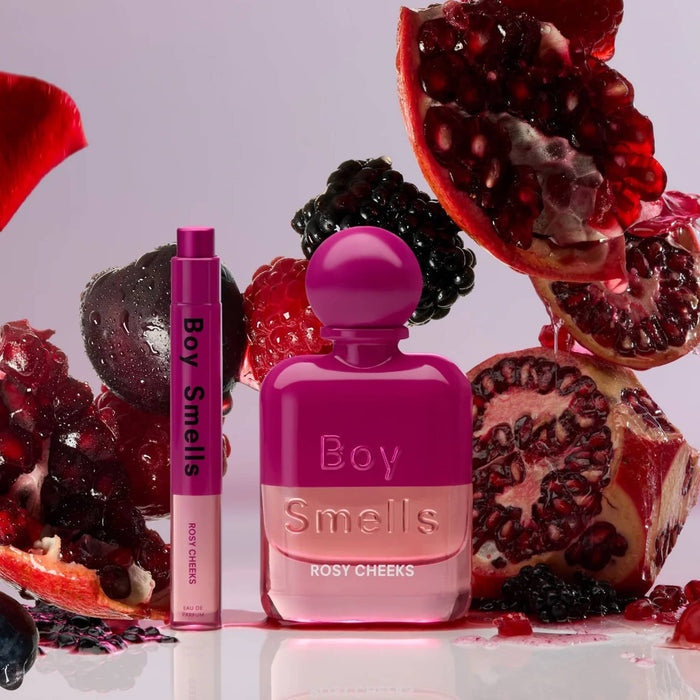 Boy Smells Rosy Cheeks scented eau de parfum 10ml travel spray bottle with 50ml bottle and fruit in the background.