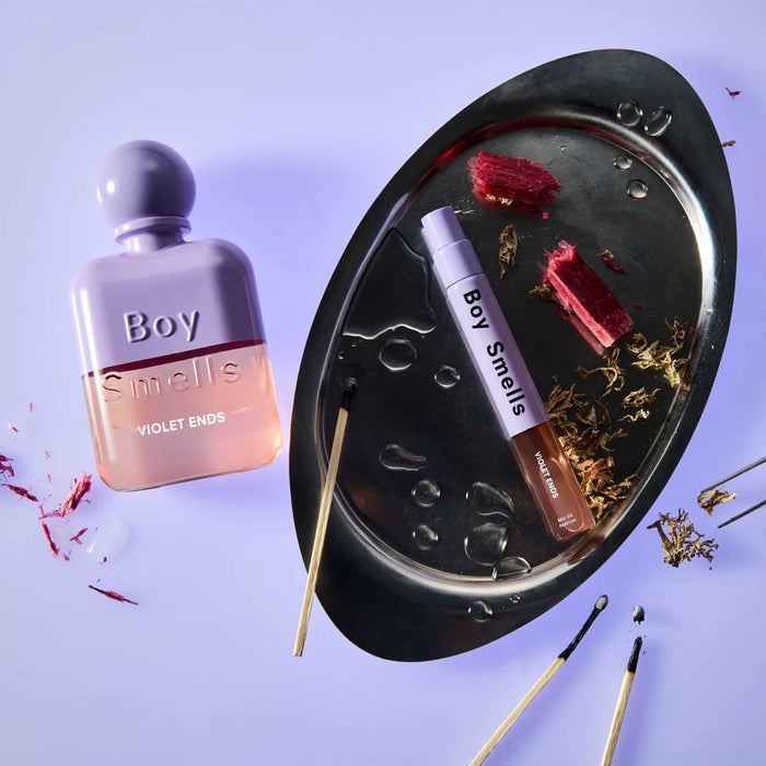 Boy Smells Violet Ends scented eau de parfum 10ml travel spray bottle and 50ml bottle with matches and incense in the background.