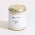 Brooklyn Candle Studio Fern + Moss scented candle in clear jar with gold lid, front view.