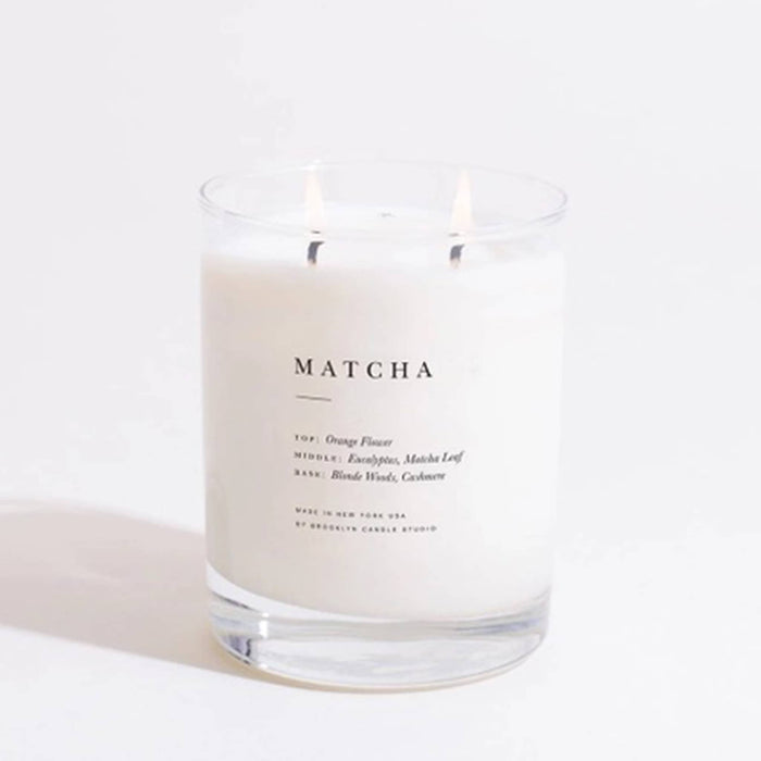 Brooklyn Candle Studio Matcha scented classic 2-wick soy wax candle, wicks lit, on a white background.