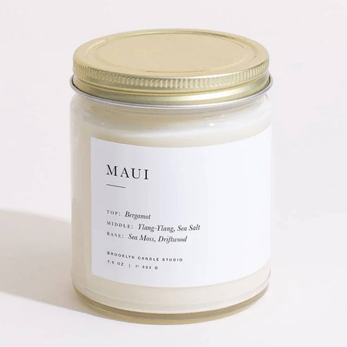 Candle jar with a gold lid and 'MAUI' label on a white background.