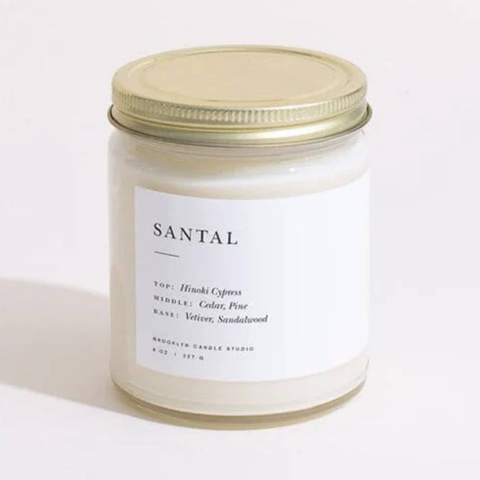 Brooklyn Candle Studio Santal scented candle in clear jar with gold lid, front view.