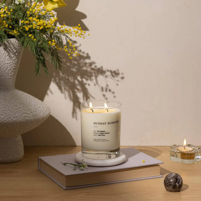 Brooklyn Candle Studio Sunday Morning scented classic 2-wick soy wax candle, lit in room setting.