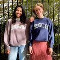 Best Regards vintage Brooklyn Varsity upcycled sweatshirt in dusty pink and royal blue, shown on models.
