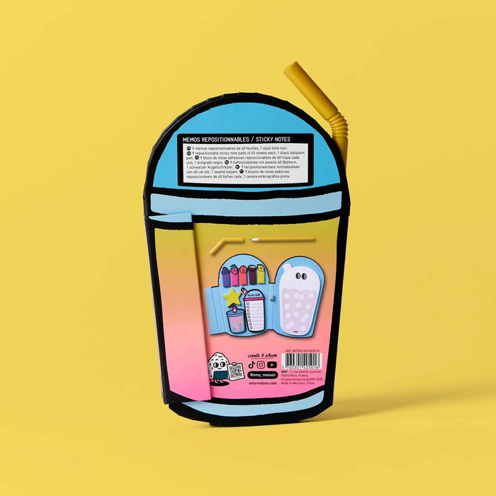 Back of a colorful stationery set in the shape of a cup with a straw-shaped pen, on a yellow background.