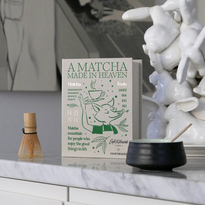 Matcha Tools Kit in beige book box packaging with green text and illustrations, with contents in front, on a marble surface.