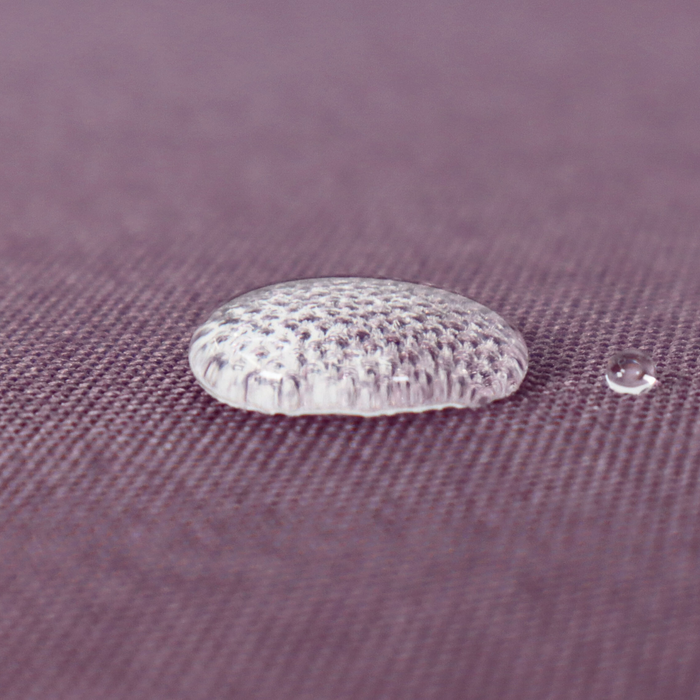 This WPC-Lite solid is a very muted purple with red undertones. This photo shows a water drop on the fabric.
